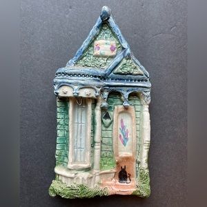 Vintage art pottery blue and green house.